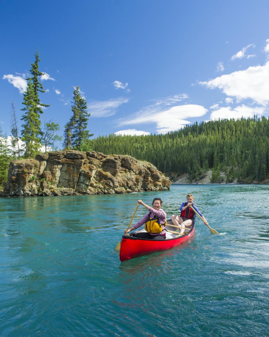 A group of paddlers canoe down Miles Canyon near Whitehorse