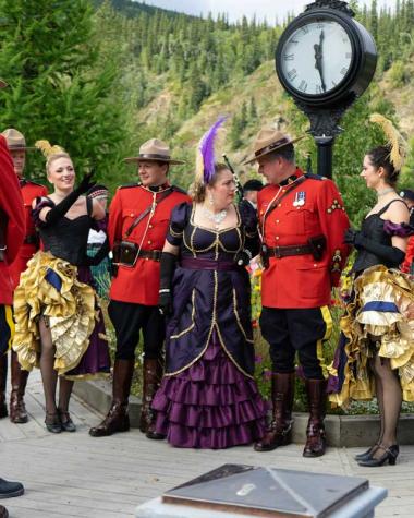 RCMP and Gertie stand in the Discovery Day celebrations