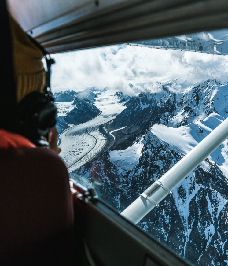 A person viewing a glacier from a plane