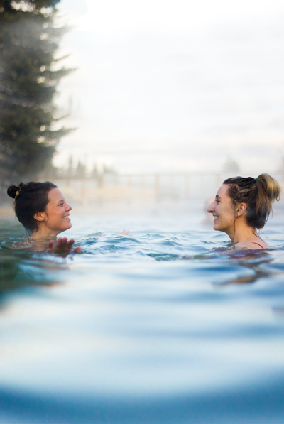 Two people sitting in a hotspring