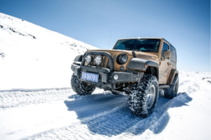 A Jeep driving on snow
