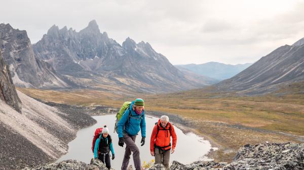 3 people hike in the tombstone mountains