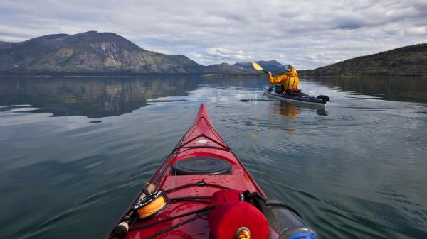 Kayaking across a lake in summer 