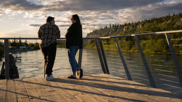 A couple enjoys the midnight sun along the Yukon River