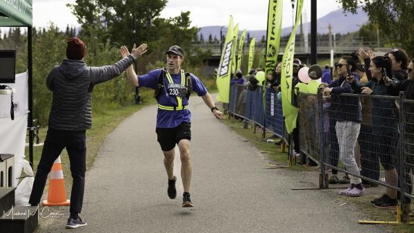 man crossing finish line