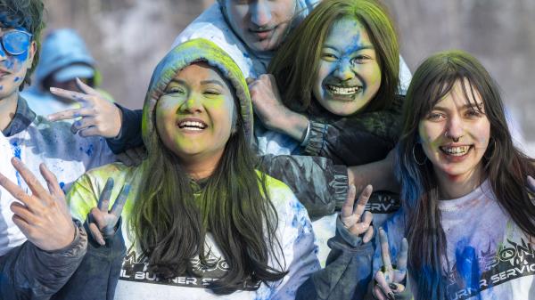 Group of girls smiling covered in rainbow powder at rendezvous