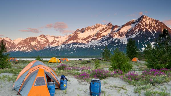 camping in the summer among tents and mountains