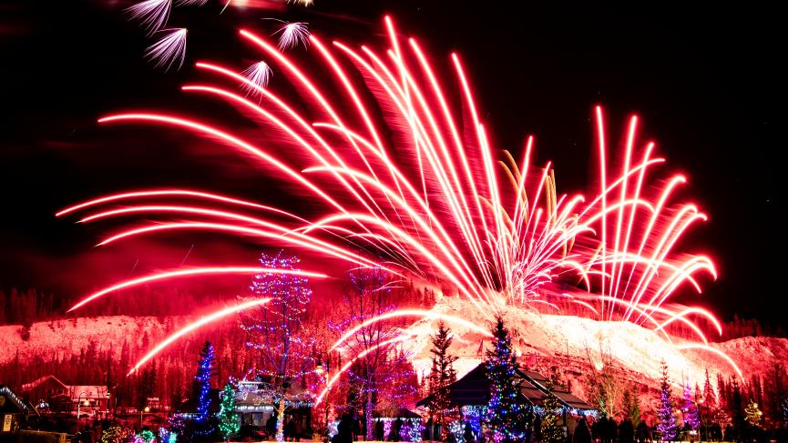 Red fireworks explore over the horizon