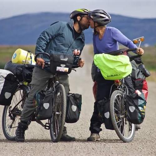 A couple stops for a kiss while biking in the Yukon