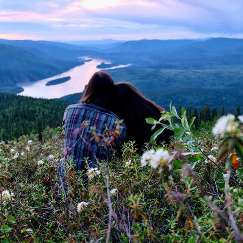 A couple leaning on each other overlooking the midnight dome
