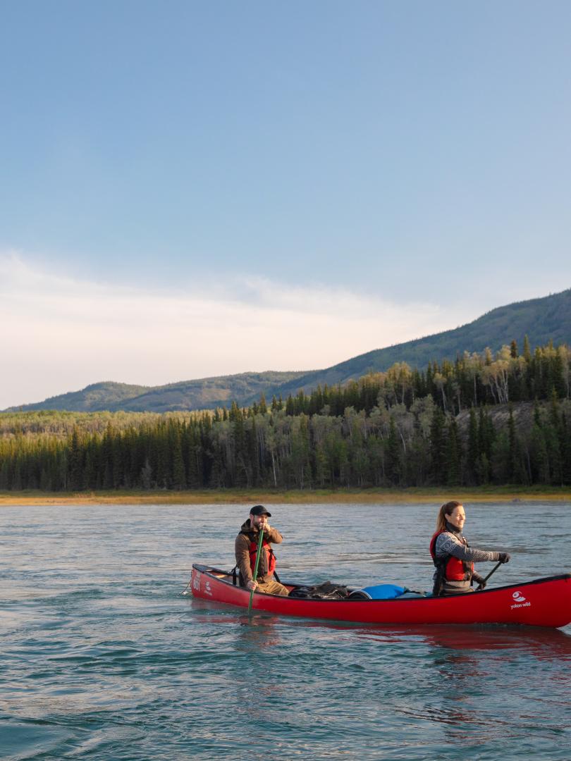 Two couples paddling on a Yukon river.