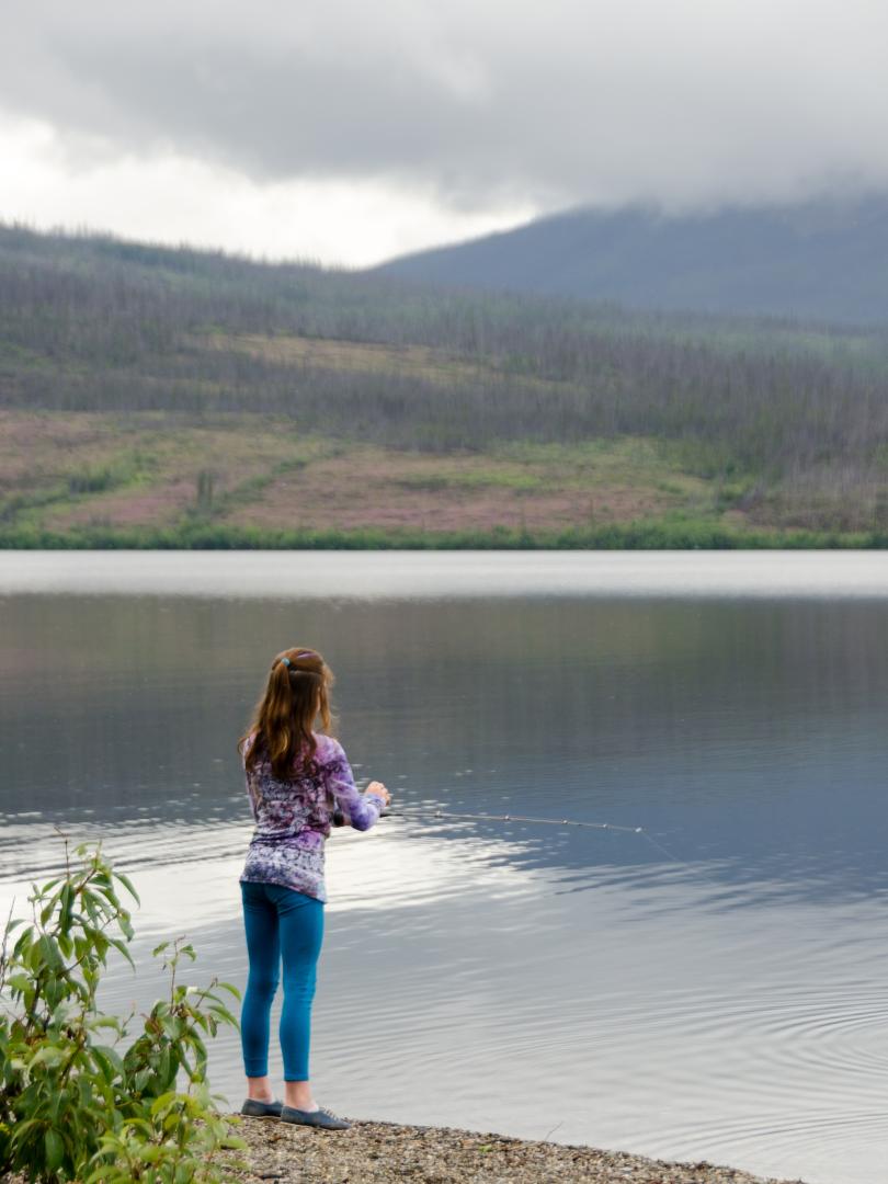 Girl fishing in large lake