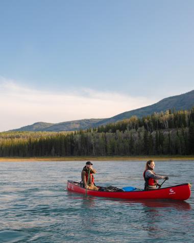 Two couples paddling on a Yukon river.