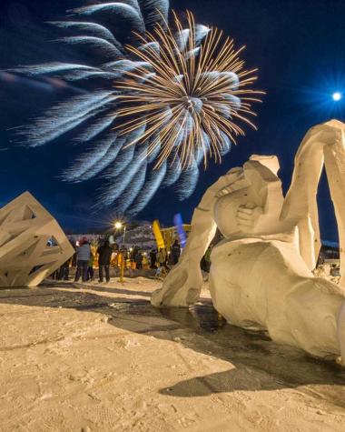 Fireworks burst over snow sculptures of the Yukon Rendezvous Festival
