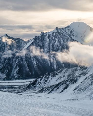 Kluane icefields and a sunbeam among clouds
