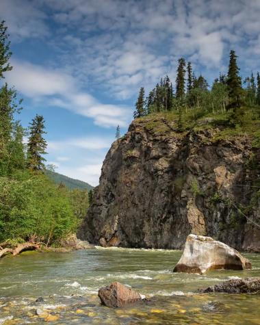 A person fly-fishes in a Yukon river